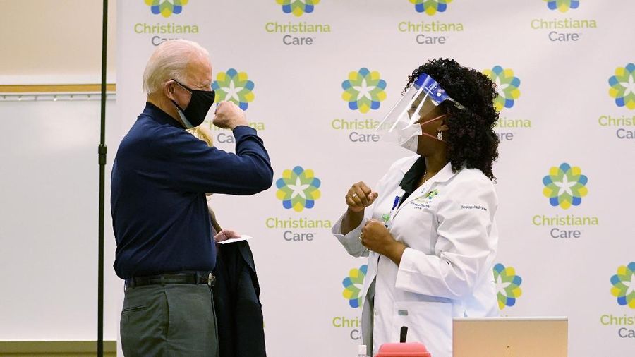 President-elect Joe Biden receives his first dose of the coronavirus vaccine from Nurse partitioner Tabe Mase at Christiana Hospital on live television in Newark Del., Monday, Dec. 21, 2020. (AP Photo/Carolyn Kaster)