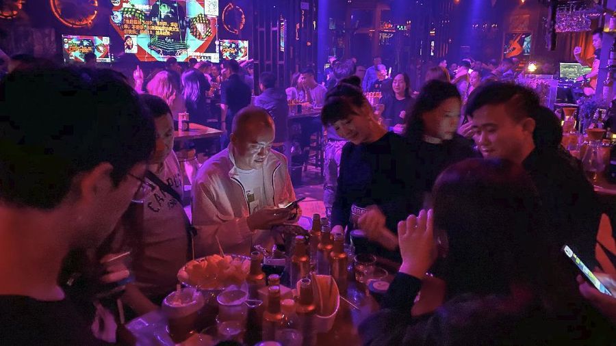 Residents enjoy night life at a club in Wuhan in central China's Hubei province on Sunday, Oct. 18, 2020. (AP Photo/Ng Han Guan)