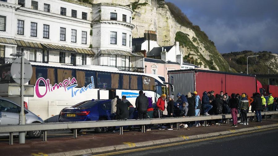 French officers make a COVID-19 test to a truck driver in the Port of Dover in Dover, England, Thursday, Dec. 24, 2020. Freight from Britain and passengers with a negative virus test have begun arriving on French shores, after France relaxed a two-day blockade over a new virus variant. The blockade had isolated Britain, stranded thousands of drivers and raised fears of shortages. (AP Photo/Alberto Pezzali)