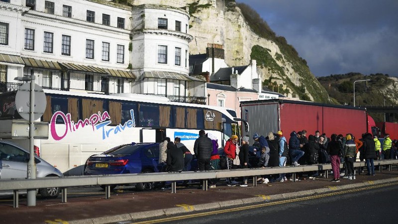 French officers make a COVID-19 test to a truck driver in the Port of Dover in Dover, England, Thursday, Dec. 24, 2020. Freight from Britain and passengers with a negative virus test have begun arriving on French shores, after France relaxed a two-day blockade over a new virus variant. The blockade had isolated Britain, stranded thousands of drivers and raised fears of shortages. (AP Photo/Alberto Pezzali)