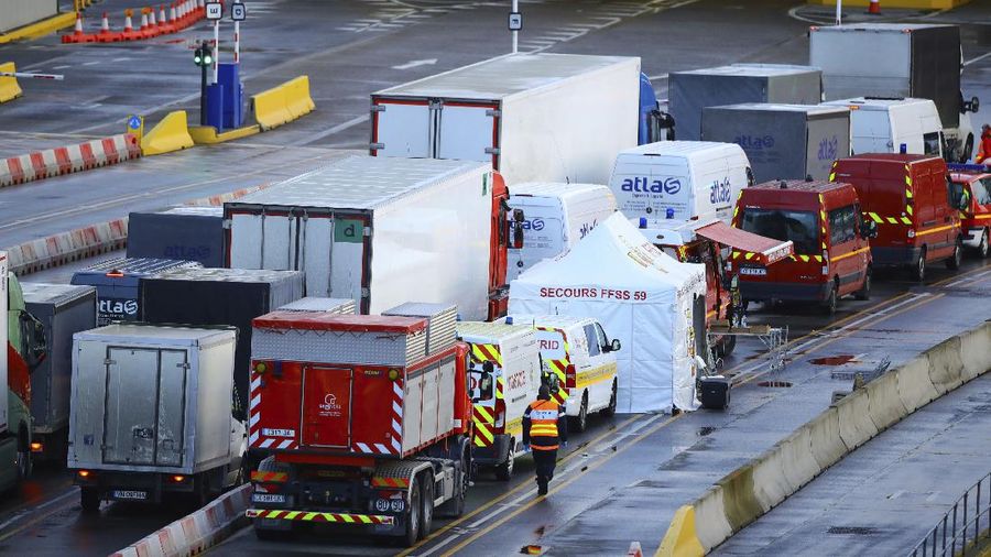 French officers make a COVID-19 test to a truck driver in the Port of Dover in Dover, England, Thursday, Dec. 24, 2020. Freight from Britain and passengers with a negative virus test have begun arriving on French shores, after France relaxed a two-day blockade over a new virus variant. The blockade had isolated Britain, stranded thousands of drivers and raised fears of shortages. (AP Photo/Alberto Pezzali)