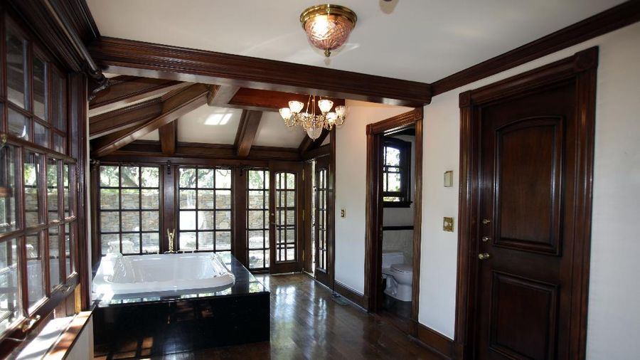 FILE - This Dec. 17, 2004, file photo shows the rear entrance to pop star Michael Jackson's Neverland Ranch home in Santa Ynez, Calif. Jackson’s Neverland Ranch has found a new owner in billionaire businessman Ron Burkle.  Burkle’s spokesman said in an email Thursday, Dec. 24, 2020, that Burkle bought the 2,700-acre property near Santa Barbara, California. (AP Photo/Mark J. Terrill, file)