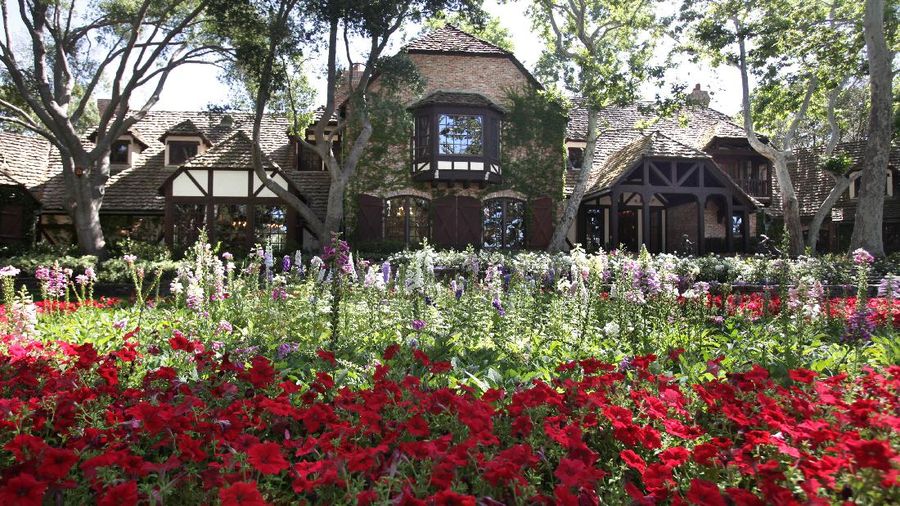 FILE - This Dec. 17, 2004, file photo shows the rear entrance to pop star Michael Jackson's Neverland Ranch home in Santa Ynez, Calif. Jackson’s Neverland Ranch has found a new owner in billionaire businessman Ron Burkle.  Burkle’s spokesman said in an email Thursday, Dec. 24, 2020, that Burkle bought the 2,700-acre property near Santa Barbara, California. (AP Photo/Mark J. Terrill, file)