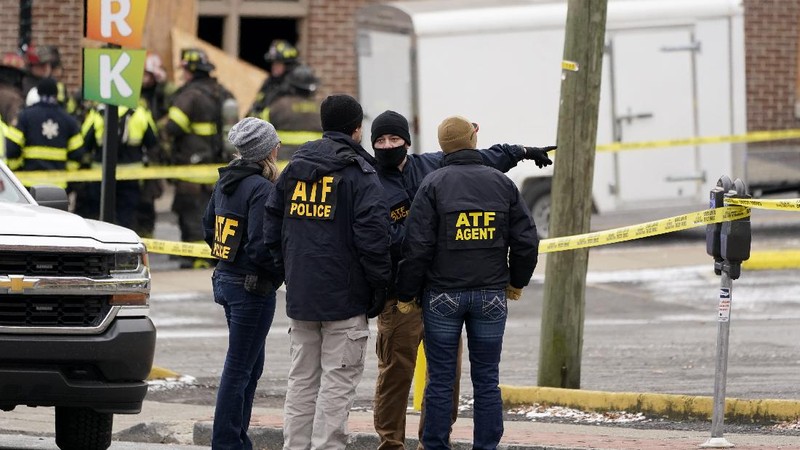 A law enforcement member walks past damage from an explosion in downtown Nashville, Tenn., Friday, Dec. 25, 2020. Buildings shook in the immediate area and beyond after a loud boom was heard early Christmas morning. (AP Photo/Mark Humphrey)