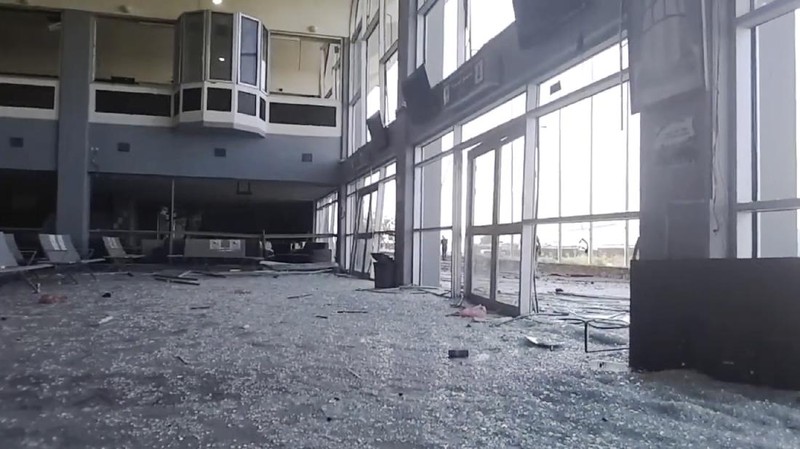 People run following an explosion at the airport in Aden, Yemen, shortly after a plane carrying the newly formed Cabinet landed on Wednesday, Dec. 30, 2020. No one on board the government plane was hurt but initial reports said several people at the airport were killed. (AP Photo)