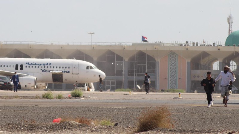 People run following an explosion at the airport in Aden, Yemen, shortly after a plane carrying the newly formed Cabinet landed on Wednesday, Dec. 30, 2020. No one on board the government plane was hurt but initial reports said several people at the airport were killed. (AP Photo)