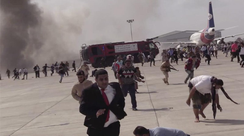 People run following an explosion at the airport in Aden, Yemen, shortly after a plane carrying the newly formed Cabinet landed on Wednesday, Dec. 30, 2020. No one on board the government plane was hurt but initial reports said several people at the airport were killed. (AP Photo)
