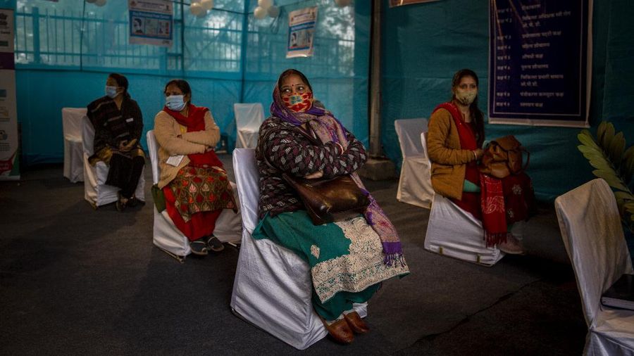 People participating in a COVID-19 vaccine delivery system trial wait for their turn at a COVID-19 vaccination center in New Delhi, India, Saturday, Jan. 2, 2021. India tested its COVID-19 vaccine delivery system with a nationwide trial on Saturday as it prepares to roll-out an inoculation program to stem the coronavirus pandemic. Saturday's exercise included necessary data entry into an online platform for monitoring vaccine delivery, along with testing of cold storage and transportation arrangements for the vaccine, the health ministry had said. (AP Photo/Altaf Qadri)