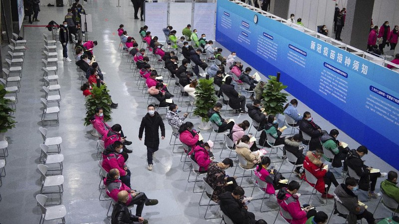 In this photo released by Xinhua News Agency, residents wait to receive their COVID-19 vaccinations at a temporary vaccination site in Beijing, Saturday, Jan. 2, 2021. China authorized its first homegrown COVID-19 vaccine for general use on Dec. 31, 2020, adding another shot that could see wide use in poorer countries as the virus surges back around the globe. (Chen Zhonghao/Xinhua via AP)