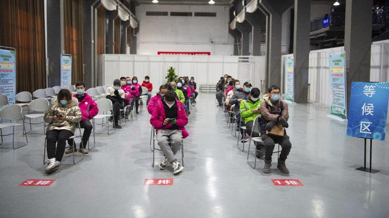 In this photo released by Xinhua News Agency, residents wait to receive their COVID-19 vaccinations at a temporary vaccination site in Beijing, Saturday, Jan. 2, 2021. China authorized its first homegrown COVID-19 vaccine for general use on Dec. 31, 2020, adding another shot that could see wide use in poorer countries as the virus surges back around the globe. (Chen Zhonghao/Xinhua via AP)