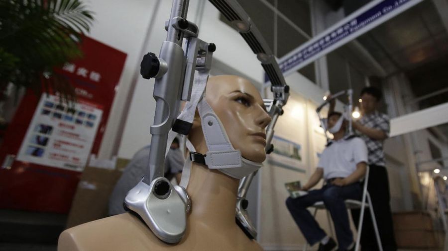 A mannequin with the cervical spine immobilization device is displayed at China Medical Beauty and Plastic Surgery Equipment Exhibition in Shanghai, China, Wednesday, June 5, 2013. (AP Photo/Eugene Hoshiko)