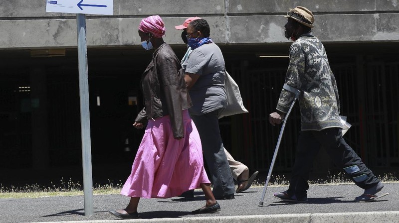 Medical workers prepare a COVID positive patient for a CT Scan at a clinic in Johannesburg Sunday, Dec. 27, 2020. South Africa's COVID-19 spike has taken the country to more than 1 million confirmed cases with hospitals reaching capacity and no sign of the new surge reaching a peak. (AP Photo/Shiraaz Mohamed.