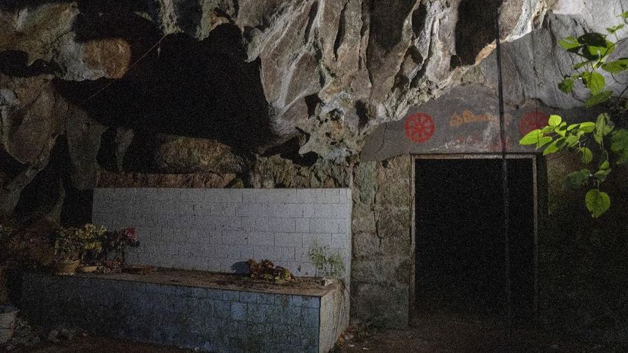 A man stands inside the abandoned Wanling cave near Manhaguo village in southern China's Yunnan province on Wednesday, Dec. 2, 2020. Villagers said the cave had been used as a sacred altar presided over by a Buddhist monk _ precisely the kind of contact between bats and people that alarms scientists. (AP Photo/Ng Han Guan)