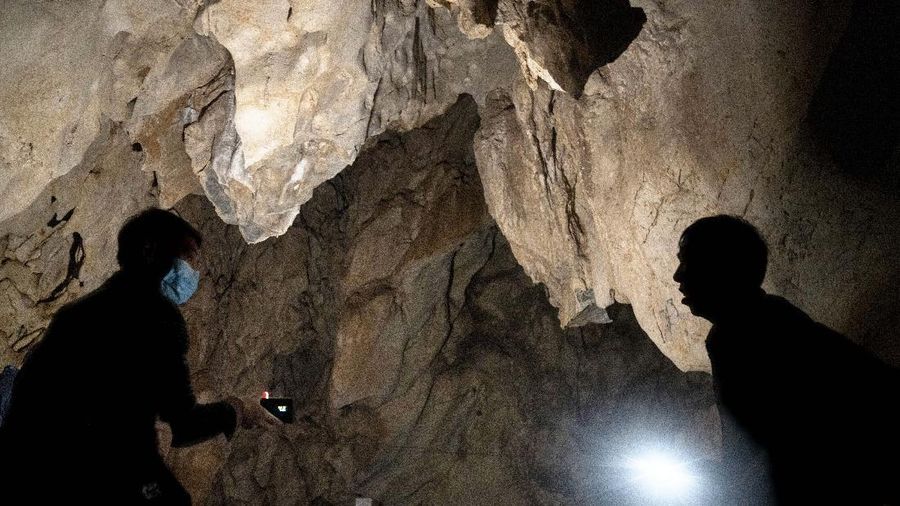 A man stands inside the abandoned Wanling cave near Manhaguo village in southern China's Yunnan province on Wednesday, Dec. 2, 2020. Villagers said the cave had been used as a sacred altar presided over by a Buddhist monk _ precisely the kind of contact between bats and people that alarms scientists. (AP Photo/Ng Han Guan)