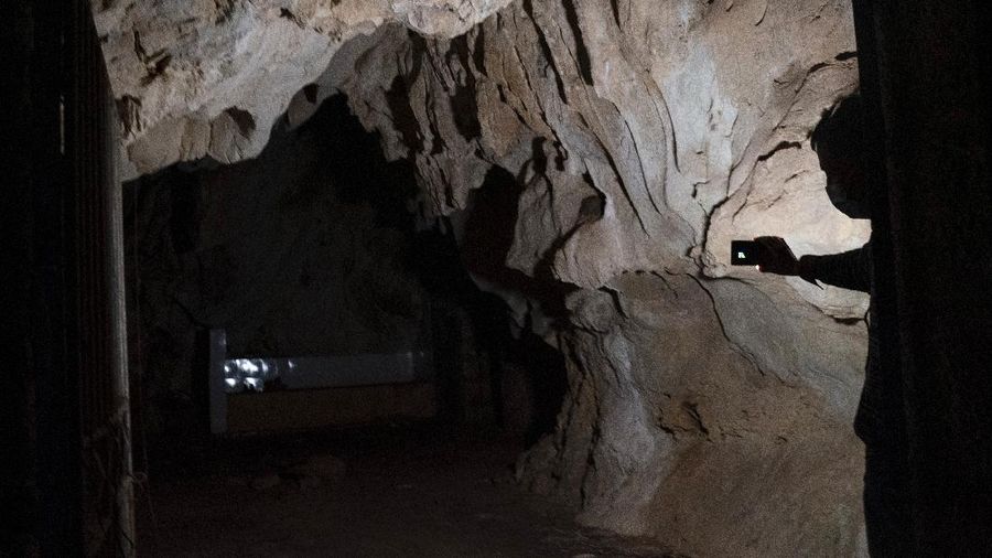 A man stands inside the abandoned Wanling cave near Manhaguo village in southern China's Yunnan province on Wednesday, Dec. 2, 2020. Villagers said the cave had been used as a sacred altar presided over by a Buddhist monk _ precisely the kind of contact between bats and people that alarms scientists. (AP Photo/Ng Han Guan)