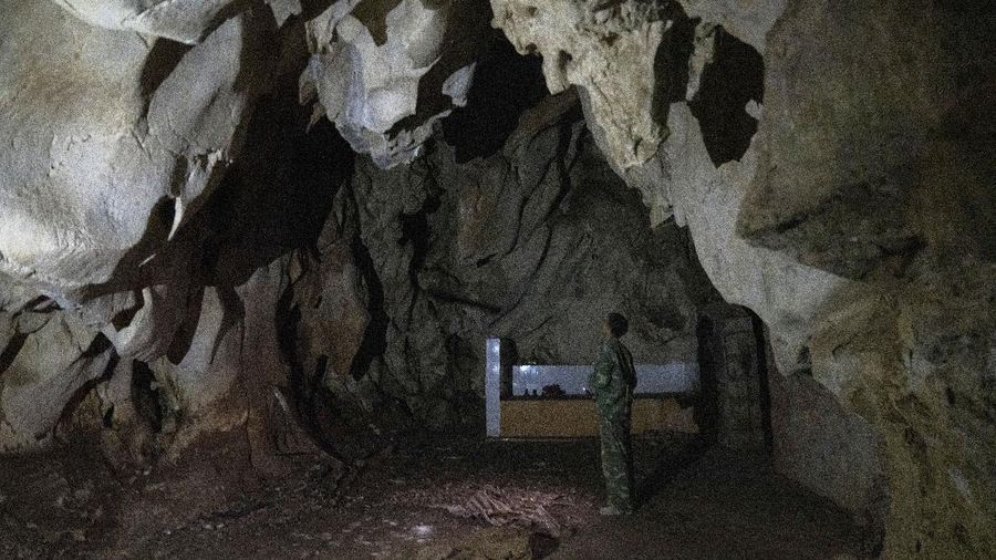 A man stands inside the abandoned Wanling cave near Manhaguo village in southern China's Yunnan province on Wednesday, Dec. 2, 2020. Villagers said the cave had been used as a sacred altar presided over by a Buddhist monk _ precisely the kind of contact between bats and people that alarms scientists. (AP Photo/Ng Han Guan)