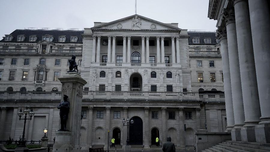 A man walks backdropped by the Bank of England in the City of London financial district in London, Jan. 5, 2021, on the first morning of England entering a third national lockdown since the coronavirus outbreak began. British Prime Minister Boris Johnson on Monday night announced a tough new stay-at-home order that will last at least six weeks, as authorities struggle to stem a surge in COVID-19 infections that threatens to overwhelm hospitals around the U.K. (AP Photo/Matt Dunham)