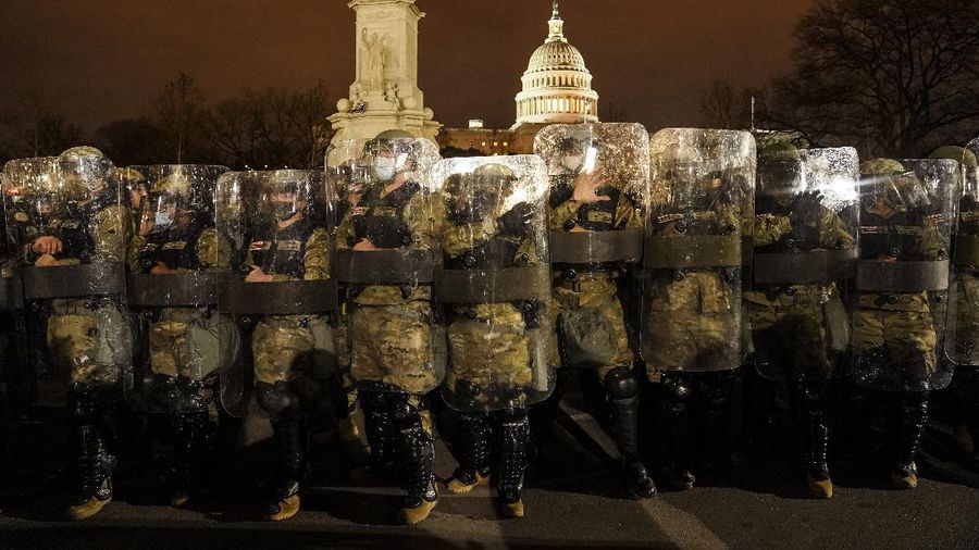 People shelter in the House gallery as protesters try to break into the House Chamber at the U.S. Capitol on Wednesday, Jan. 6, 2021, in Washington. (AP Photo/Andrew Harnik)
