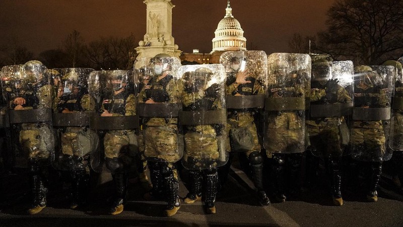 People shelter in the House gallery as protesters try to break into the House Chamber at the U.S. Capitol on Wednesday, Jan. 6, 2021, in Washington. (AP Photo/Andrew Harnik)