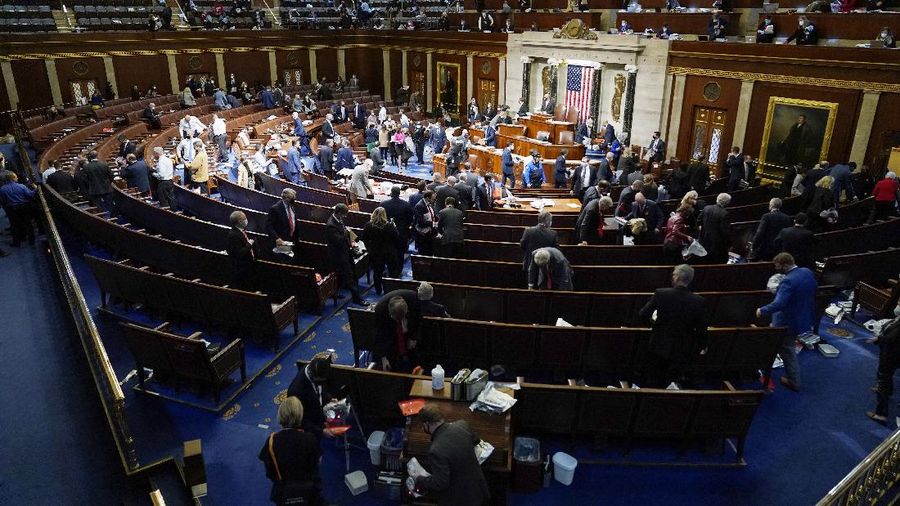 People shelter in the House gallery as protesters try to break into the House Chamber at the U.S. Capitol on Wednesday, Jan. 6, 2021, in Washington. (AP Photo/Andrew Harnik)