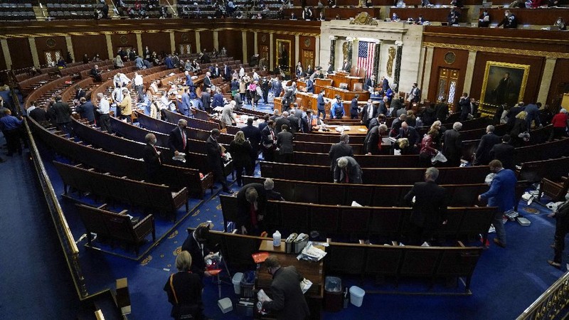 People shelter in the House gallery as protesters try to break into the House Chamber at the U.S. Capitol on Wednesday, Jan. 6, 2021, in Washington. (AP Photo/Andrew Harnik)