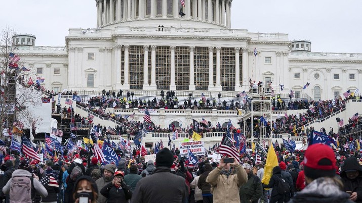 Trump supporters gather outside the Capitol, Wednesday, Jan. 6, 2021, in Washington. As Congress prepares to affirm President-elect Joe Biden's victory, thousands of people have gathered to show their support for President Donald Trump and his claims of election fraud. (AP Photo/Jose Luis Magana)