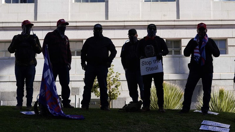 A Trump supporter is detained by LAPD officers after a brawl with counter protesters  in Los Angeles on Wednesday, Jan. 6, 2021. (Sarah Reingewirtz/The Orange County Register via AP)