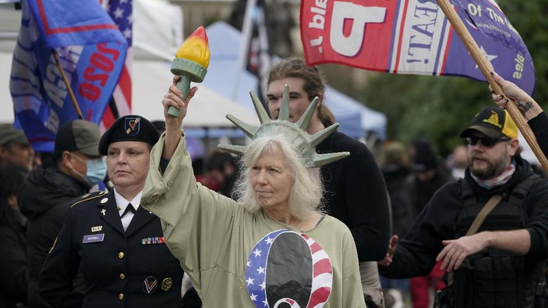 With the Washington Monument in the background, people attend a rally in support of President Donald Trump on Wednesday, Jan. 6, 2021, in Washington. (AP Photo/Jose Luis Magana)