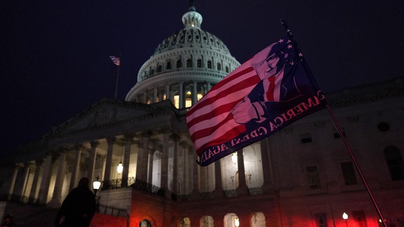 People shelter in the House gallery as protesters try to break into the House Chamber at the U.S. Capitol on Wednesday, Jan. 6, 2021, in Washington. (AP Photo/Andrew Harnik)