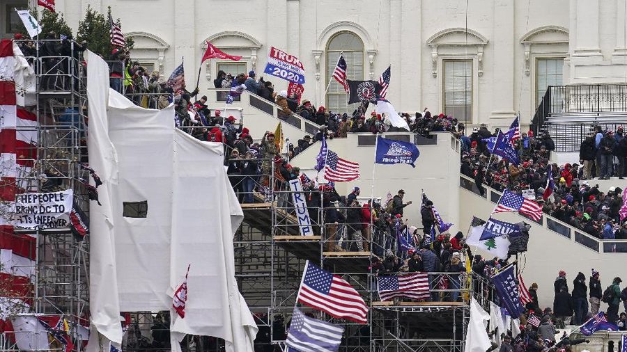 Trump supporters gather outside the Capitol, Wednesday, Jan. 6, 2021, in Washington. As Congress prepares to affirm President-elect Joe Biden's victory, thousands of people have gathered to show their support for President Donald Trump and his claims of election fraud. (AP Photo/John Minchillo)