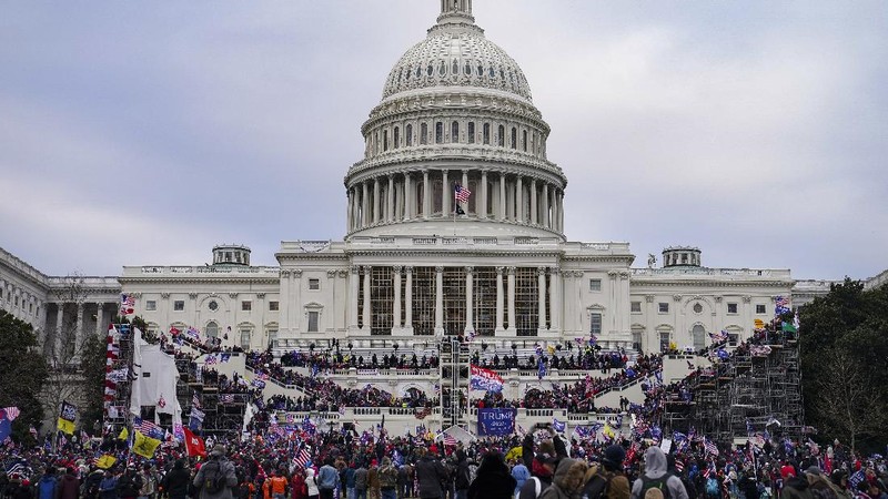 People shelter in the House gallery as protesters try to break into the House Chamber at the U.S. Capitol on Wednesday, Jan. 6, 2021, in Washington. (AP Photo/Andrew Harnik)