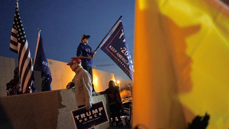 A Trump supporter is detained by LAPD officers after a brawl with counter protesters  in Los Angeles on Wednesday, Jan. 6, 2021. (Sarah Reingewirtz/The Orange County Register via AP)