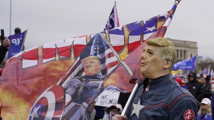 Electoral College Protests Oklahoma Robert Ramsey of Tulsa, Okla., wears a Trump mask at a rally at the Oklahoma Capitol, Wednesday, Jan. 6, 2021, in Oklahoma City. (AP Photo/Sue Ogrocki)