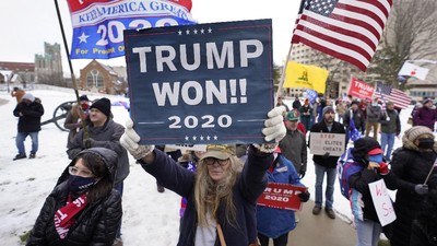 People attend a rally in support of President Donald Trump at the state capitol in Lansing, Mich., Wednesday, Jan. 6, 2021. (AP Photo/Paul Sancya)