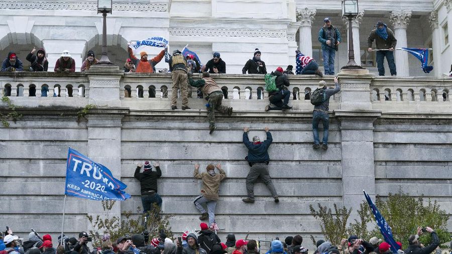 Trump supporters try to break through a police barrier, Wednesday, Jan. 6, 2021, at the Capitol in Washington. As Congress prepares to affirm President-elect Joe Biden's victory, thousands of people have gathered to show their support for President Donald Trump and his claims of election fraud. (AP Photo/Julio Cortez)