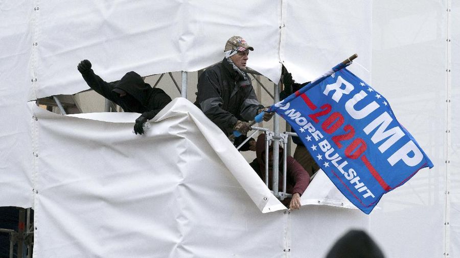 Trump supporters are seen outside the Capitol, Wednesday, Jan. 6, 2021, in Washington. As Congress prepares to affirm President-elect Joe Biden's victory, thousands of people have gathered to show their support for President Donald Trump and his claims of election fraud. (AP Photo/Jose Luis Magana)