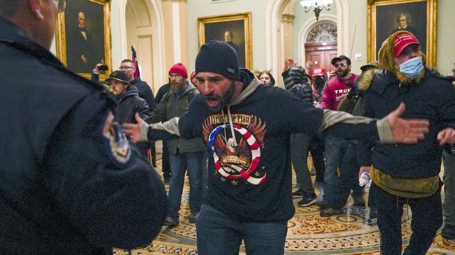 Trump supporters try to break through a police barrier, Wednesday, Jan. 6, 2021, at the Capitol in Washington. As Congress prepares to affirm President-elect Joe Biden's victory, thousands of people have gathered to show their support for President Donald Trump and his claims of election fraud. (AP Photo/Julio Cortez)