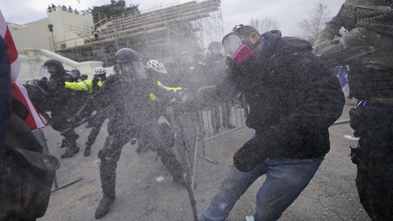 Trump supporters try to break through a police barrier, Wednesday, Jan. 6, 2021, at the Capitol in Washington. As Congress prepares to affirm President-elect Joe Biden's victory, thousands of people have gathered to show their support for President Donald Trump and his claims of election fraud. (AP Photo/Julio Cortez)