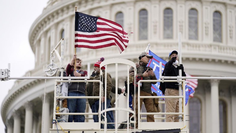 Trump supporters try to break through a police barrier, Wednesday, Jan. 6, 2021, at the Capitol in Washington. As Congress prepares to affirm President-elect Joe Biden's victory, thousands of people have gathered to show their support for President Donald Trump and his claims of election fraud. (AP Photo/Julio Cortez)