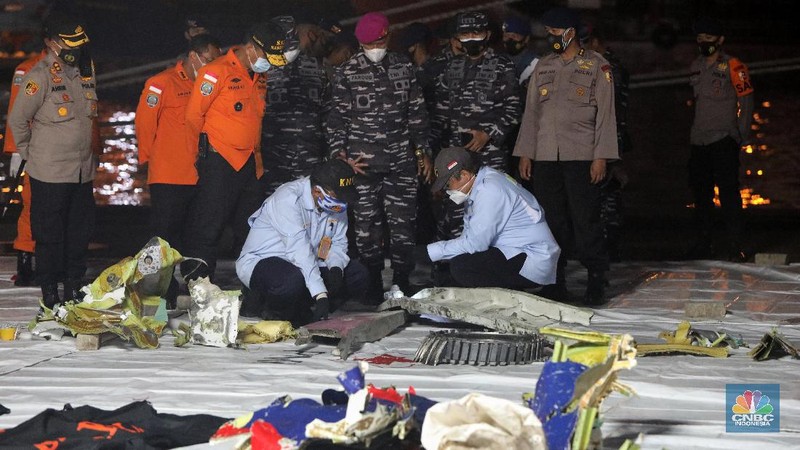 Tim Sar membawa temuan sebagian pesawat dari air selama operasi pencarian jet penumpang Sriwijaya Air yang jatuh ke laut dekat Jakarta, Indonesia, Minggu, 10 Januari 2021.