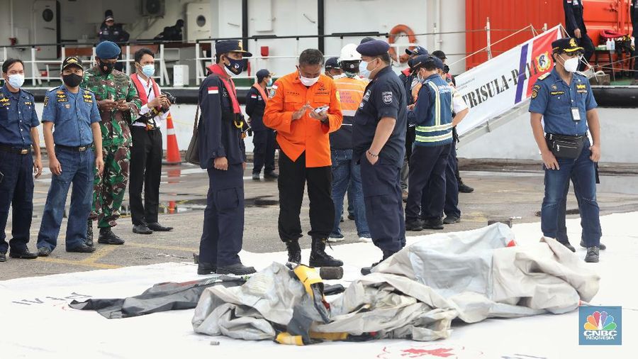 Petugas SAR memeriksa temuan tangga darurat dari kecelakaan pesawat Sriwijaya pesawat Sriwijaya Air SJ-182 di wilayah Kepulauan Seribu, Jakarta, Minggu (10/1/2021).  (CNBC Indonesia/Andrean Kristianto)