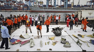 Parts of aircrafts found on the waters off Java Island where a Sriwijaya Air passenger jet crashed are laid out for inspection, at Tanjung Priok Port in Jakarta, Indonesia, Monday, Jan. 11, 2021. The search for the black boxes of a crashed Sriwijaya Air jet intensified Monday to boost the investigation into what caused the plane carrying dozens of people to nosedive at high velocity into the Java Sea. (AP Photo/Dita Alangkara)