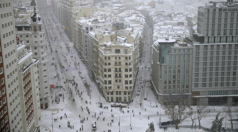 A man snowboards at the Gran Via avenue in downtown Madrid, Spain, Sunday, Jan. 10, 2021. A large part of central Spain including the capital of Madrid are slowly clearing snow after the country's worst snowstorm in recent memory. (AP Photo/Manu Fernandez)