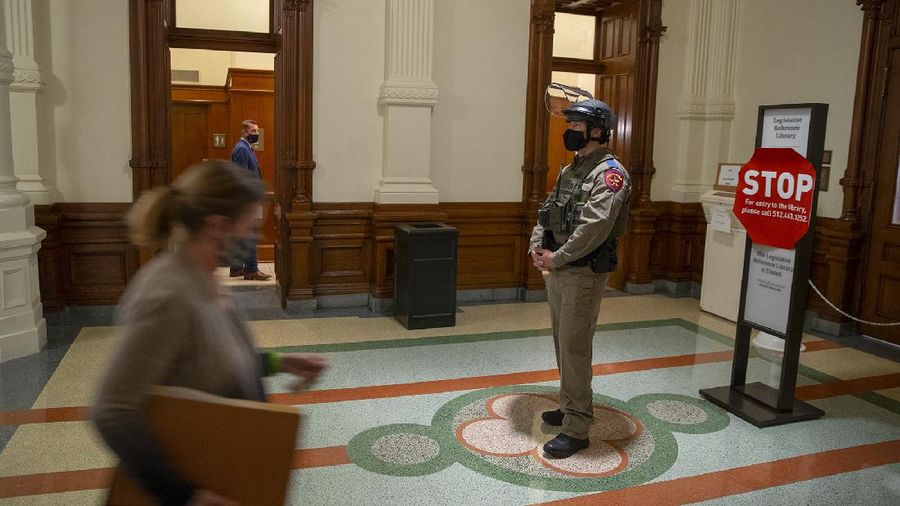 DPS state troopers and the National Guard protect the Capitol on the first day of the 87th Legislature, Tuesday Jan. 12, 2021 in Austin, Texas. More than 100 Texas troopers, including dozens wearing tactical vests and carrying riot gear, stood on guard outside the state Capitol on Tuesday as lawmakers returned to work amid FBI warnings of armed protests at statehouses across the country. (Ricardo B. Brazziell/Austin American-Statesman via AP)