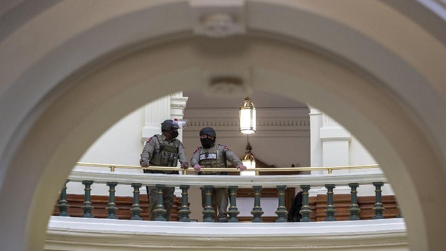 DPS state troopers and the National Guard protect the Capitol on the first day of the 87th Legislature, Tuesday Jan. 12, 2021 in Austin, Texas. More than 100 Texas troopers, including dozens wearing tactical vests and carrying riot gear, stood on guard outside the state Capitol on Tuesday as lawmakers returned to work amid FBI warnings of armed protests at statehouses across the country. (Ricardo B. Brazziell/Austin American-Statesman via AP)