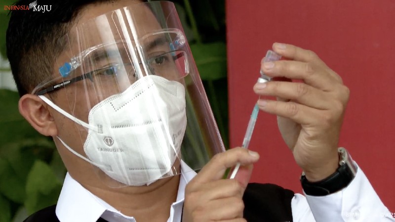 In this photo released by the Indonesian Presidential Palace, President Joko Widodo prepares to receive a shot of COVID-19 vaccine at Merdeka Palace in Jakarta, Indonesia, Wednesday, Jan. 13, 2021. Widodo on Wednesday received the first shot of a Chinese-made COVID-19 vaccine after Indonesia approved it for emergency use and began efforts to vaccine millions of people in the world's fourth most populated country. Writings on the banner in the background read 