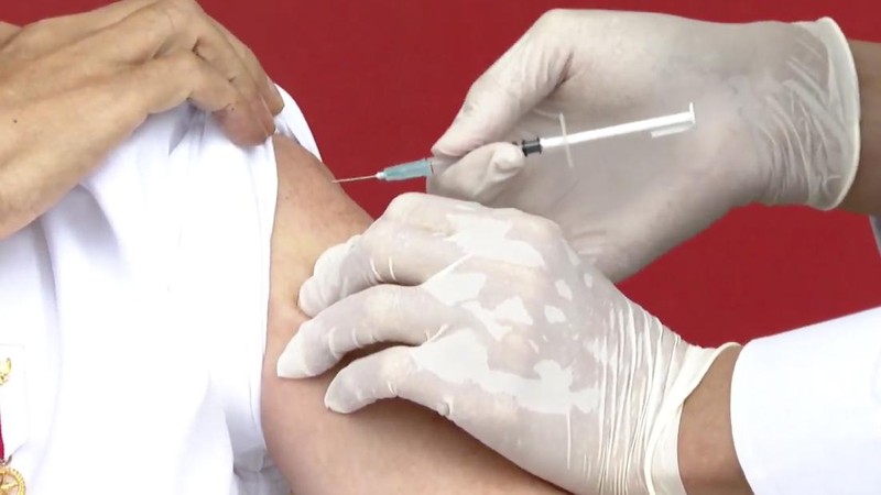 In this photo released by the Indonesian Presidential Palace, President Joko Widodo prepares to receive a shot of COVID-19 vaccine at Merdeka Palace in Jakarta, Indonesia, Wednesday, Jan. 13, 2021. Widodo on Wednesday received the first shot of a Chinese-made COVID-19 vaccine after Indonesia approved it for emergency use and began efforts to vaccine millions of people in the world's fourth most populated country. Writings on the banner in the background read 