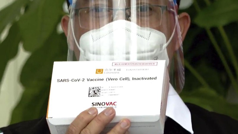 In this photo released by the Indonesian Presidential Palace, President Joko Widodo prepares to receive a shot of COVID-19 vaccine at Merdeka Palace in Jakarta, Indonesia, Wednesday, Jan. 13, 2021. Widodo on Wednesday received the first shot of a Chinese-made COVID-19 vaccine after Indonesia approved it for emergency use and began efforts to vaccine millions of people in the world's fourth most populated country. Writings on the banner in the background read 