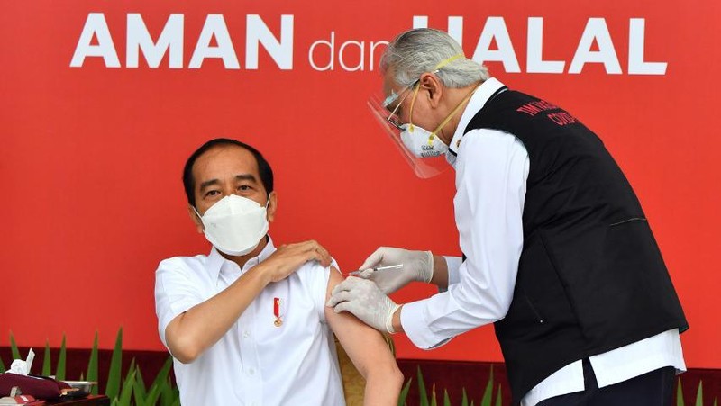 In this photo released by the Indonesian Presidential Palace, President Joko Widodo prepares to receive a shot of COVID-19 vaccine at Merdeka Palace in Jakarta, Indonesia, Wednesday, Jan. 13, 2021. Widodo on Wednesday received the first shot of a Chinese-made COVID-19 vaccine after Indonesia approved it for emergency use and began efforts to vaccine millions of people in the world's fourth most populated country. Writings on the banner in the background read 