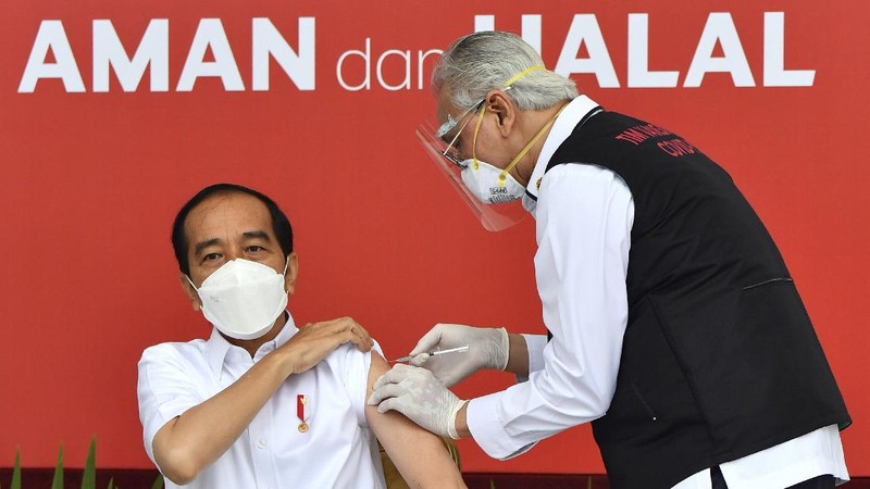 In this photo released by the Indonesian Presidential Palace, President Joko Widodo prepares to receive a shot of COVID-19 vaccine at Merdeka Palace in Jakarta, Indonesia, Wednesday, Jan. 13, 2021. Widodo on Wednesday received the first shot of a Chinese-made COVID-19 vaccine after Indonesia approved it for emergency use and began efforts to vaccine millions of people in the world's fourth most populated country. Writings on the banner in the background read 
